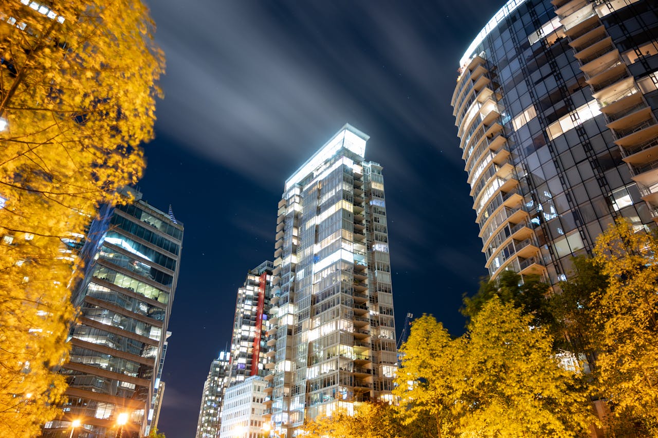 Stunning nighttime view of Vancouver's skyscrapers glowing against the dark sky.